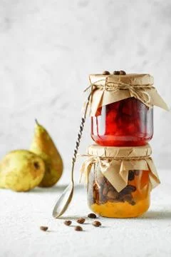 Two jars of fruit homemade jam. pear marmalade with coffee beans and Jar of b Stock Photos