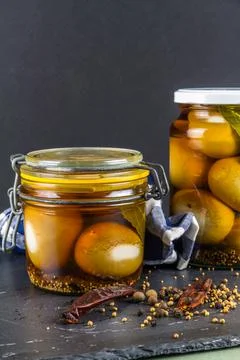 Two jars of pickled eggs, close up with pickling spices. Stock Photos
