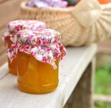 Two Jars of Pumpkin Jam on a Bench, copy space for your text Stock Photos