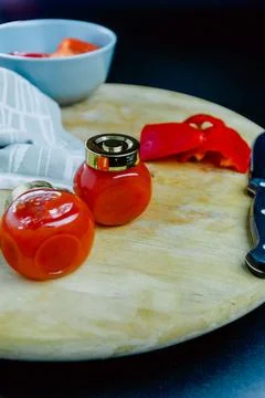 Two jars of red pepper jelly on table Stock Photos