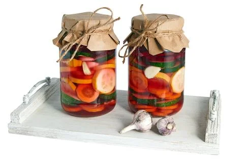Two jars of salted fermented vegetables on white wooden tray isolated on wh.. Stock Photos