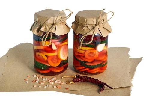 Two jars with salted fermented vegetables isolated on white background Stock Photos