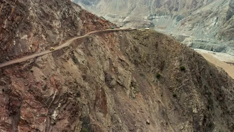 Two jeepneys passing by on mountain road to Fairy Meadows, Nanga Parbat, drone Stock Footage 132918385