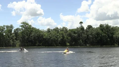 Two jet skis pulling in to the dock. Stock Footage 156417613