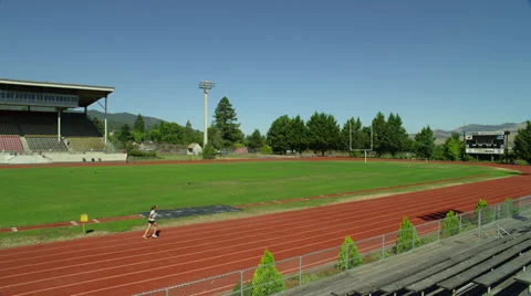 Two Joggers on High School Track Stock Footage 35284224