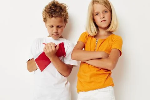 Two joyful children draw in the notebook childhood entertainment color Stock Photos