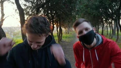 Two joyful friends dancing in the park at sunset. Young boys have fun outdoors Vidéo 106731603