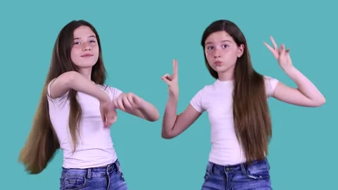 Two joyful funny twins having fun, dancing, jumping, relaxing, enjoying music Stock Footage 133061598