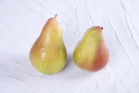 Two juicy, fresh pears on a texture background Stock Photos