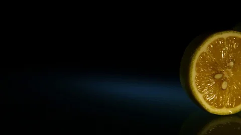 Two juicy lemons appear on a dark background. Stock Footage 89761973