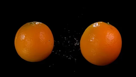Two juicy oranges are flying and colliding with each other Stock Footage 288773723