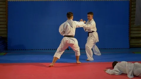 Two karate fighters attacking another and practicing self defense in slow m.. Stock Footage 76396219
