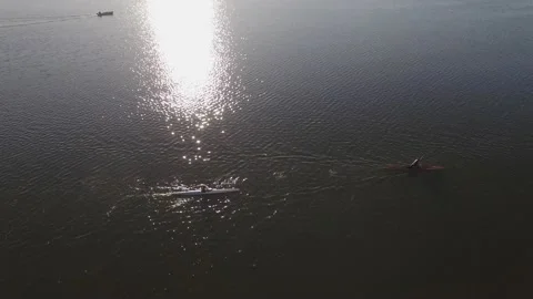 Two Kayaker on a large lake early in the evening with sunflares on water Stock Footage 217486560