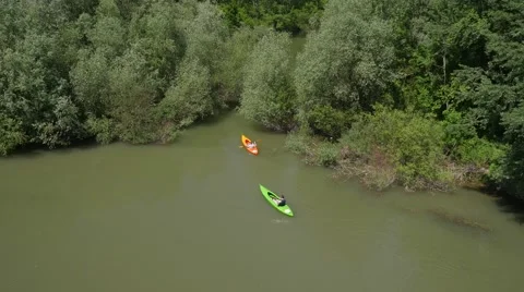 Two kayakers paddling down the river Stock Footage 58668819