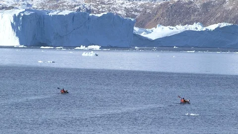 Two kayakers sailing on the Arctic Ocean, Greenland Stock-Footage 104188502