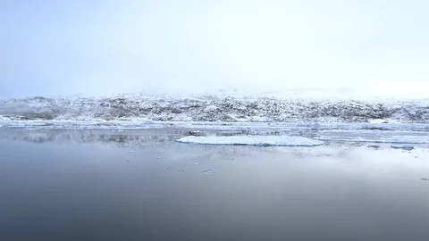 Two kayakers sailing in the middle of the ice floe, Greenland Stock Footage 104184477