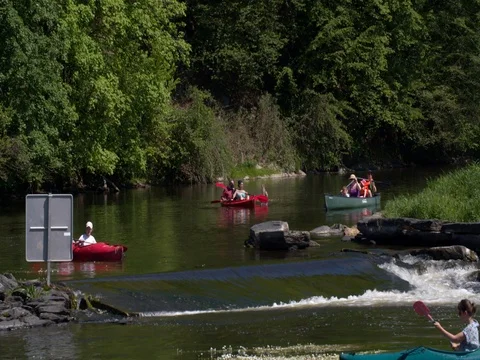 Two kayaking boys passing rapid waterfall river in the Ardennes, Belgium Stock Footage 76165221