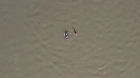 Two kayaks in different colors that are paddling through a river Video stock 146343862