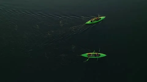 Two kayaks with four oarsmen float on water without waves. Stock Footage 172483404