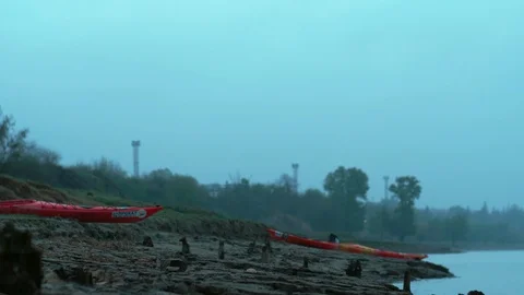 Two kayaks stand on the shore ready for SUP Video stock 109897398