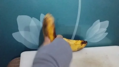 Two Kepok Bananas on the Table, One is Picked Up Stock Footage 229305006