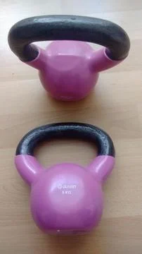 Two kettlebels pink black Stock Photos