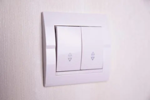 Two-key switch gray on the wall a plastic mechanical switch. Light switch ins Stock Photos