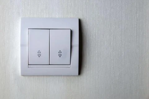 Two-key switch gray on the wall a plastic mechanical switch. Stock Photos