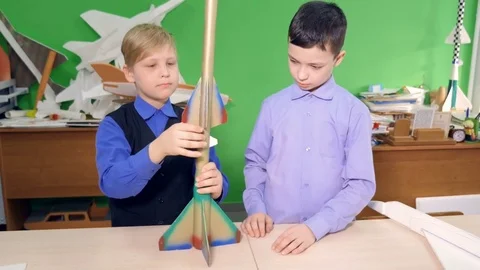Two kids are making a space rocket together Stock Footage