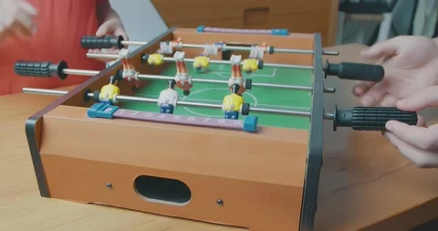 Two kids are playing table football and enjoying at home during the pandemic Stock Footage 143971125
