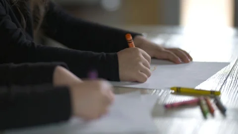 Two kids coloring with crayons at the dining table Stock-Footage 85491421