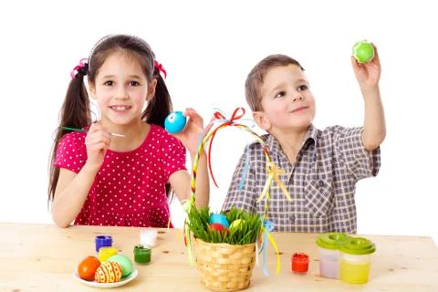 Two kids paint easter eggs Stock Photos