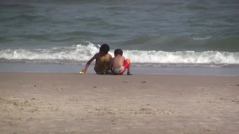 Two Kids Play on the Beach Stock Footage 132080602