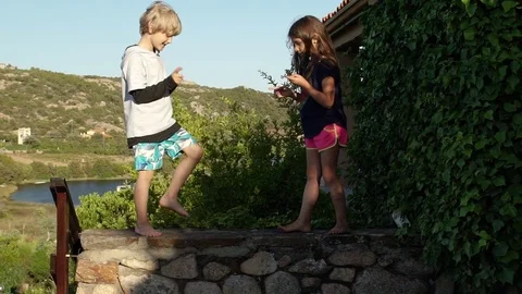 Two kids playing and dancing outside in summer, slowmo HD 스톡 동영상 78043718