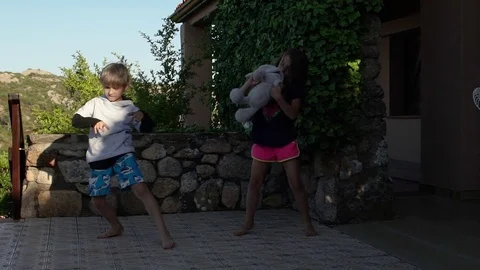 Two kids playing and dancing outside in summer, slowmo HD Vidéo 81134666
