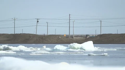 Two kids playing on an Arctic beach at Barrow, Alaska Video stock 104950971