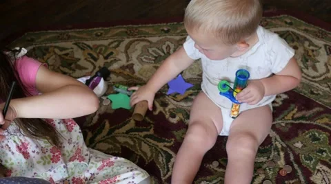 Two kids playing on the floor . Video stock 41416258