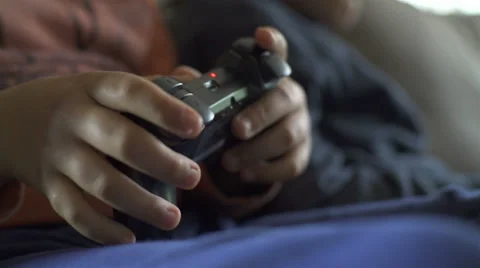 Two kids playing video games. Close Up of hands with controller Stock Footage 62653761