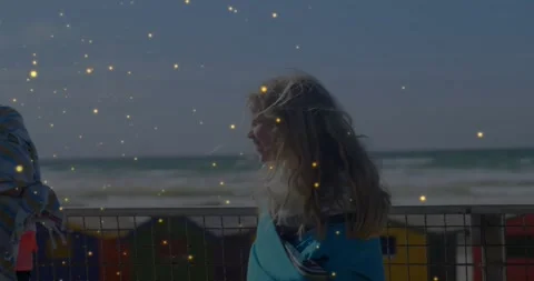 Two kids at railing, second entering and starting laughter, sparkle overlay over Stock Footage 330195138