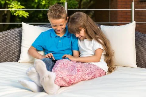 Two kids sharing tablet Stock Photos