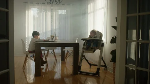 Two kids sitting on the dining table at home Video stock 119992627