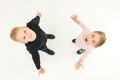 The two kids stand on the white background. View from above Photo