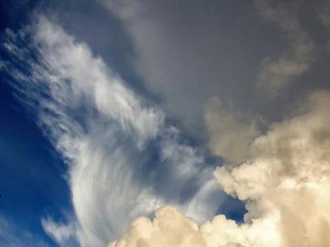 Two kind of clouds seem to collide in the sky above the farmlands of central  Foto stock
