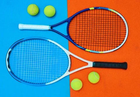 Two of a kind. High angle shot of tennis essentials placed on top of a colourful Stock Photos