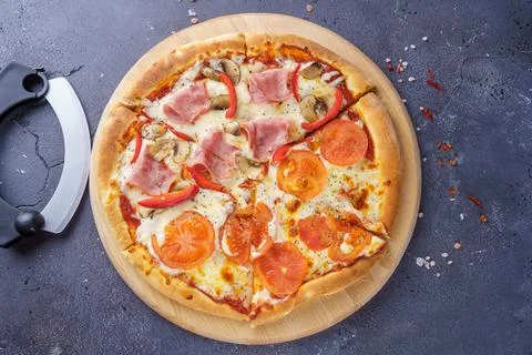 Two kind of pizza together on the same board with a pizza knife Stock-Fotos
