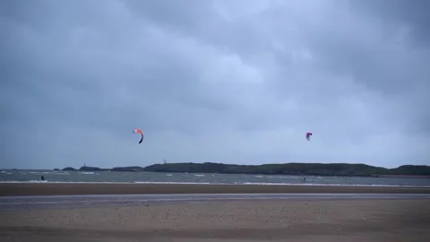 Two kite surfers are kiting on the lonely beach Stock-Footage 146171143