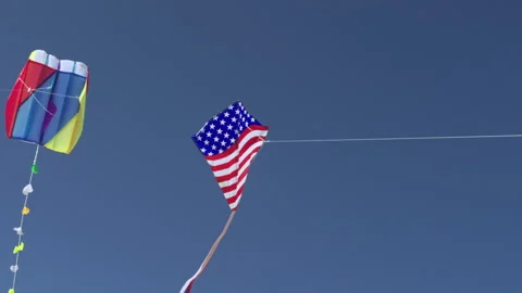 Two Kites Flying on a Blue Sky, Flag Kite Soaring Summer Day Stock Footage 171135506