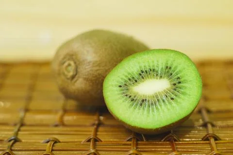 Two kiwi in a cut on a dark background Foto stock