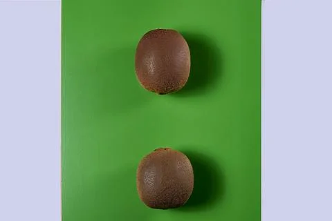 Two kiwis on green background, Stock Photos