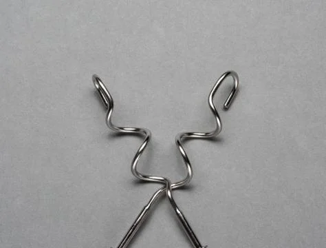 Two kneading hooks on grey background. Stock Photos